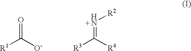 Oil-soluble imine-acid reaction products as asphaltene dispersants in crude oil