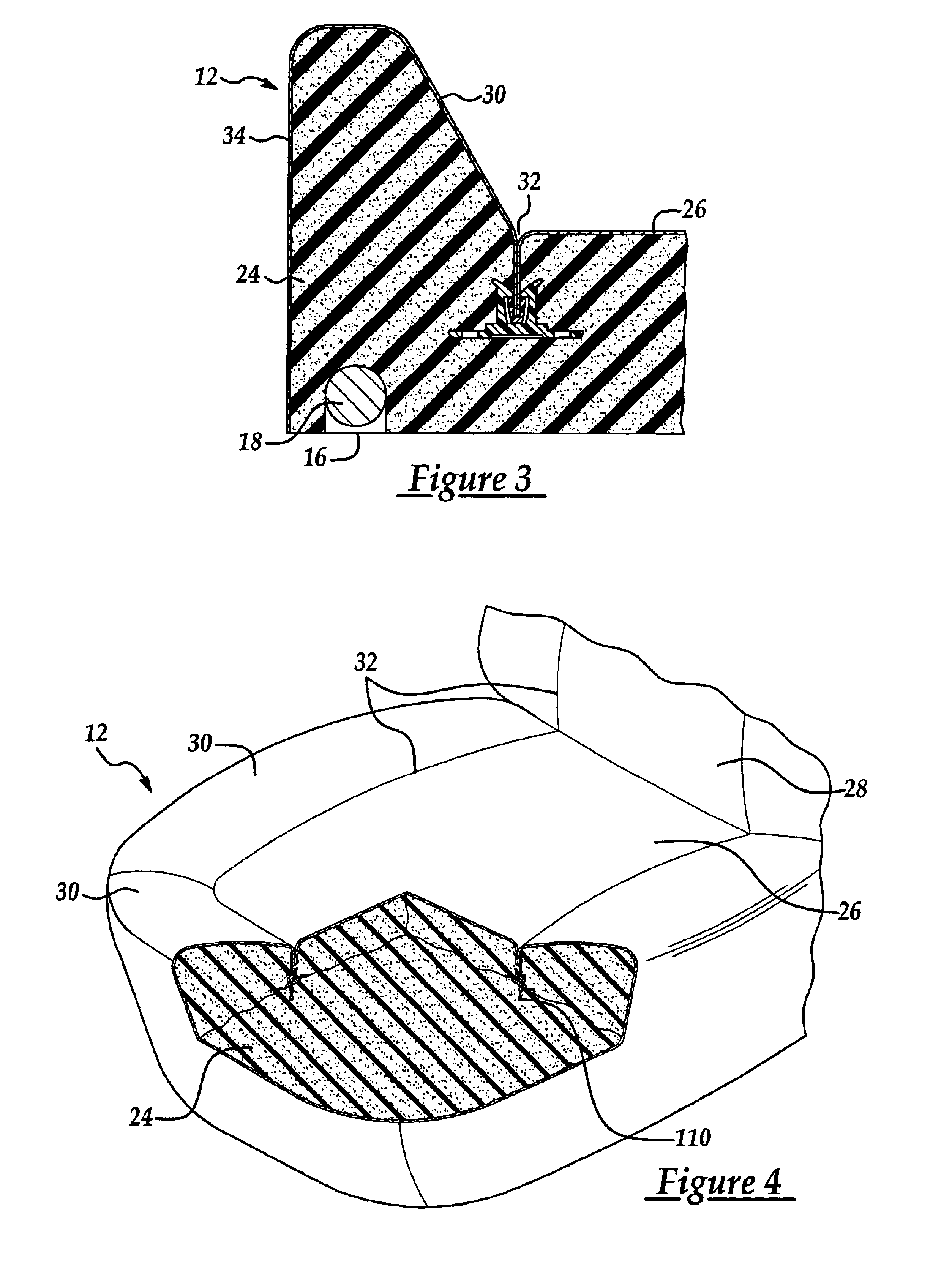 Attachment assembly for securing trim material to the padding of a vehicle seat