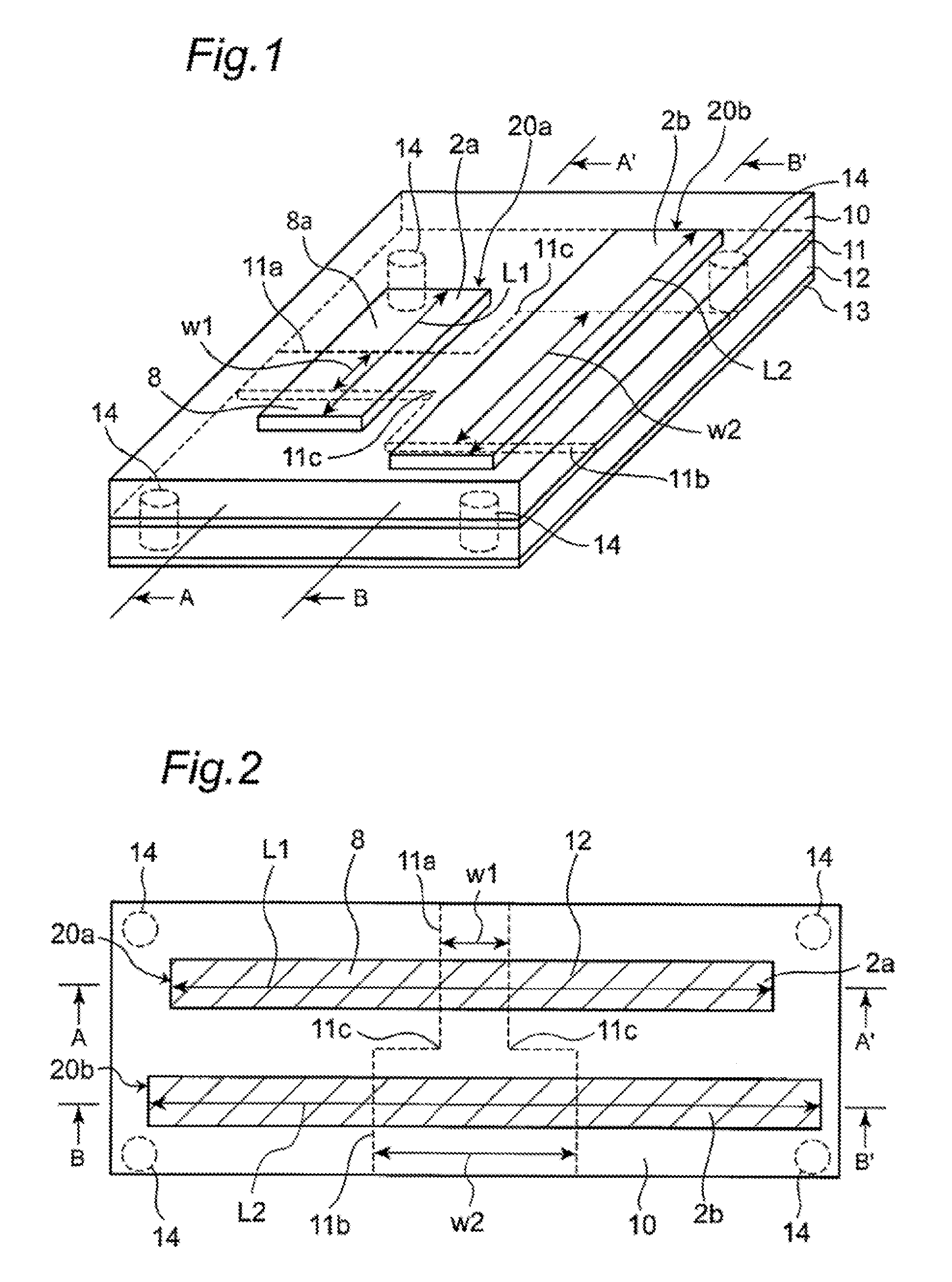 Parallel differential transmission lines having an opposing grounding conductor separated into two parts by a slot therein