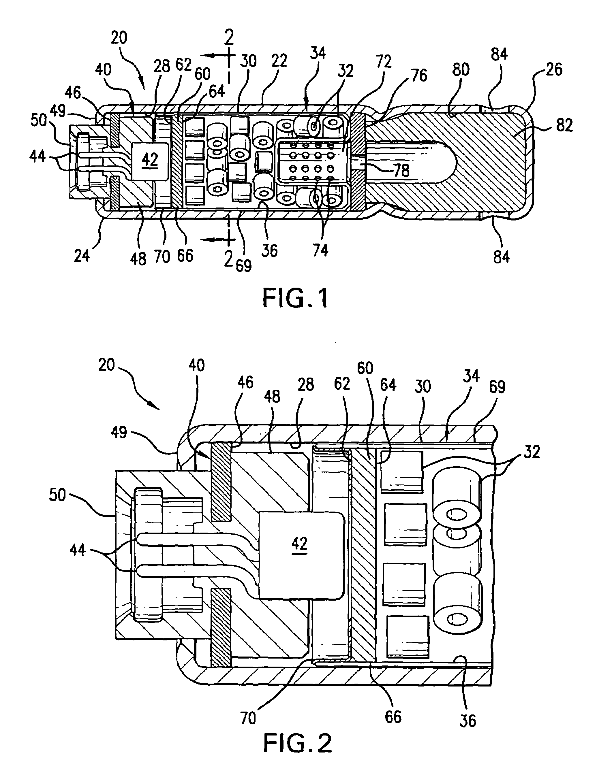 Inflator devices having a moisture barrier member