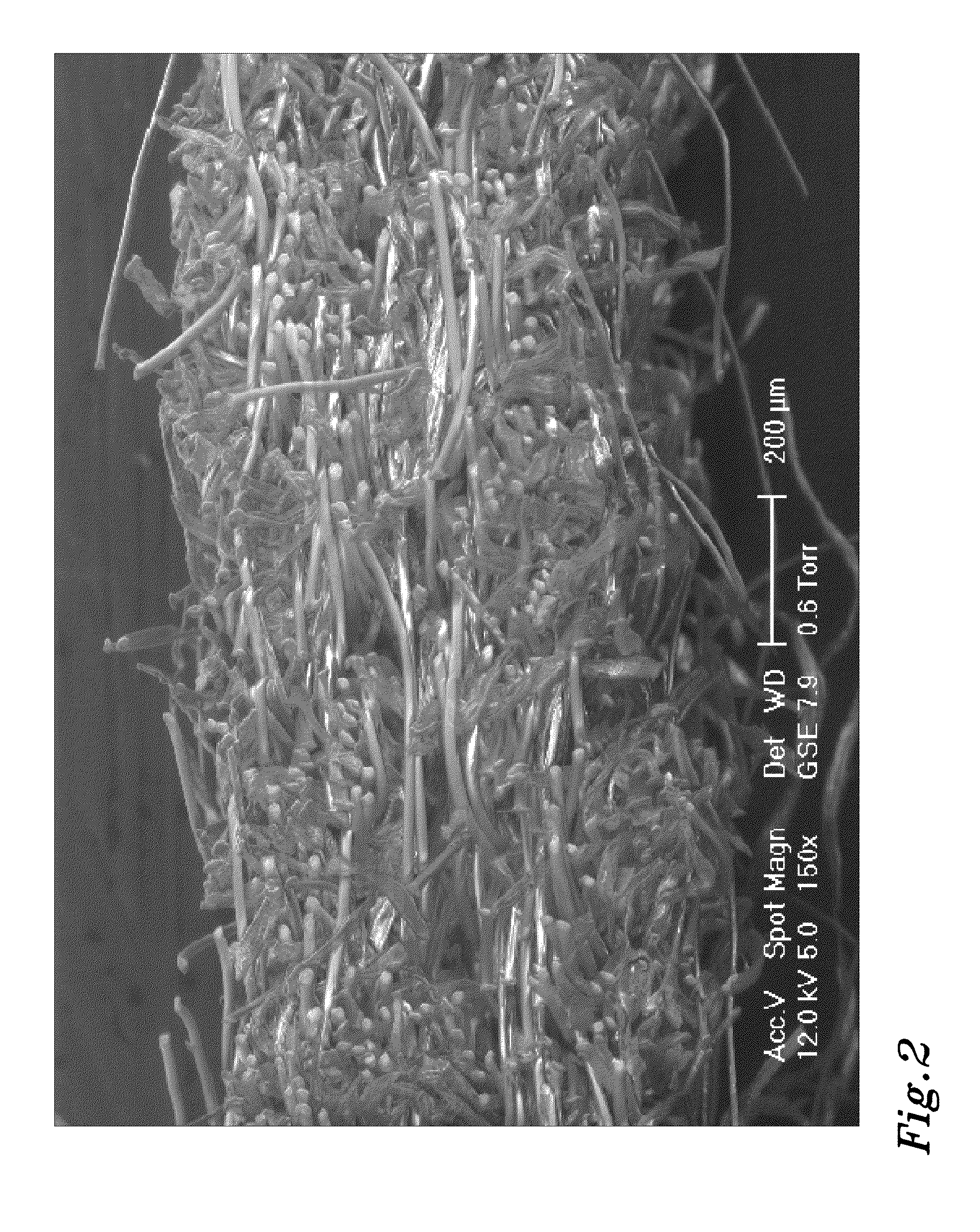 Method of producing a hydroentangled nonwoven material