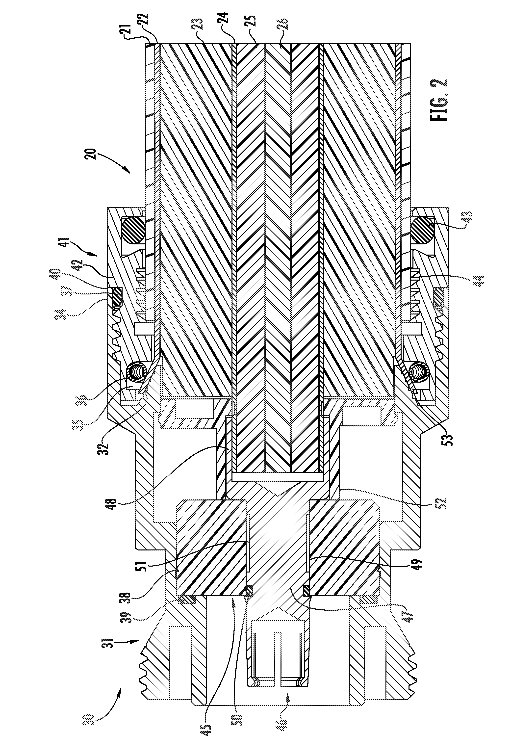 Connector for coaxial cable having rotational joint between insulator member and connector housing and associated methods