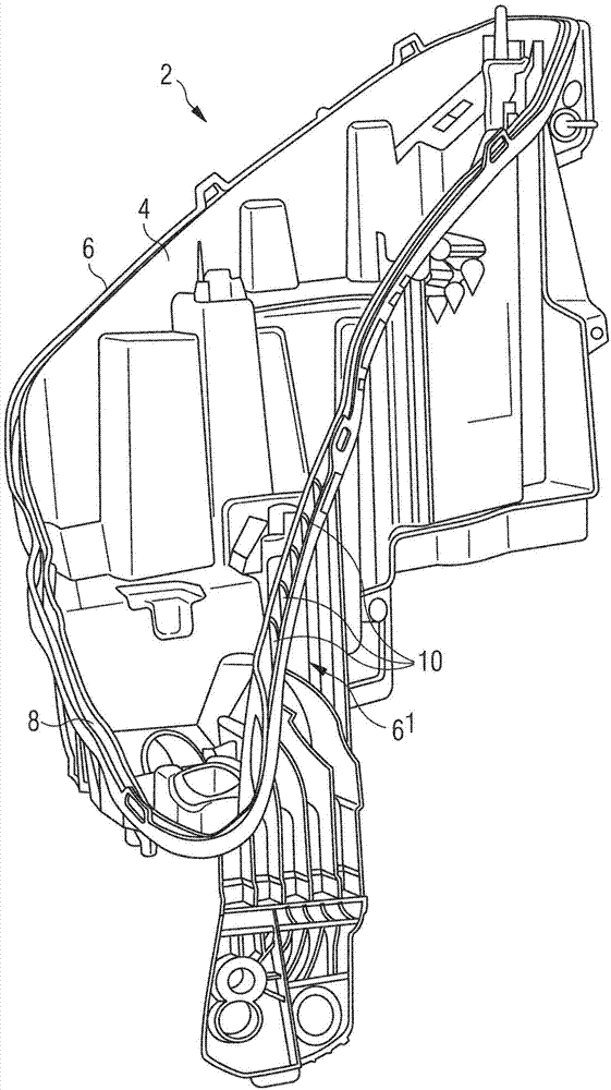 Joint between housing and headlamp outer lens with glue-retaining ribs