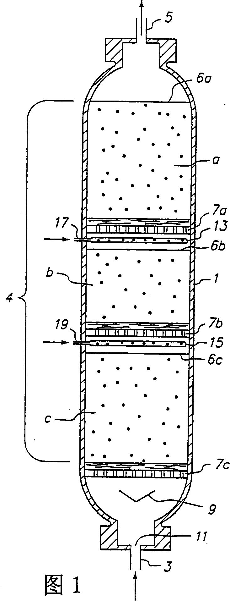 Upflow reactor system with layered catalyst bed for hydrotreating heavy feedstocks