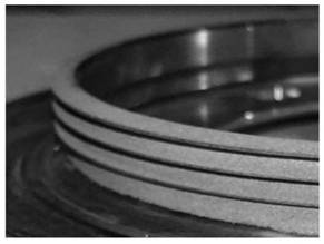 Labyrinth ring part coating removal protection clamp and labyrinth ring part surface coating repairing process